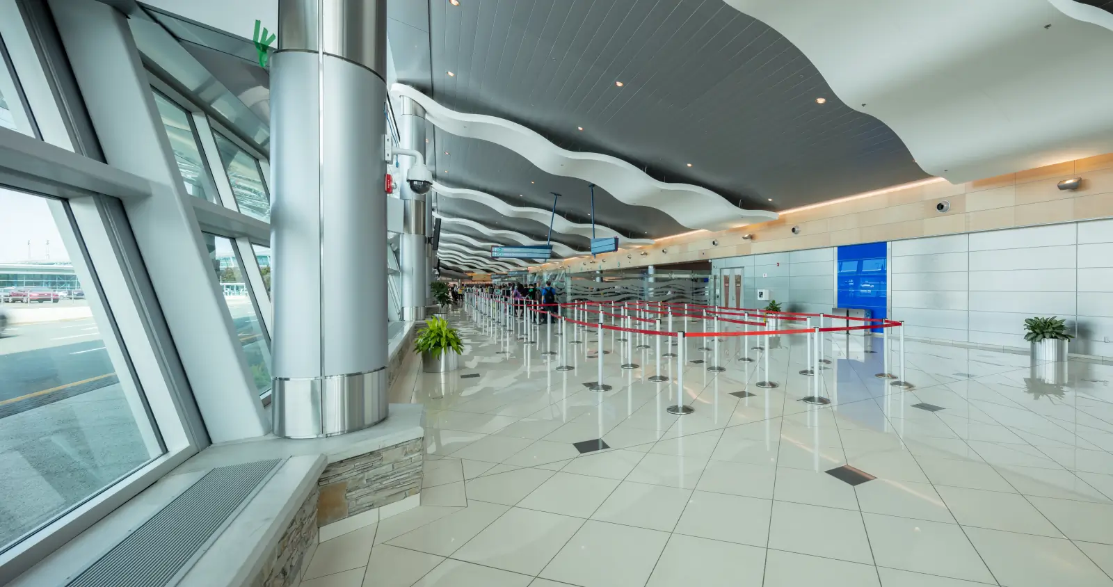 Hallway of St. John's International Airport with people waiting in line