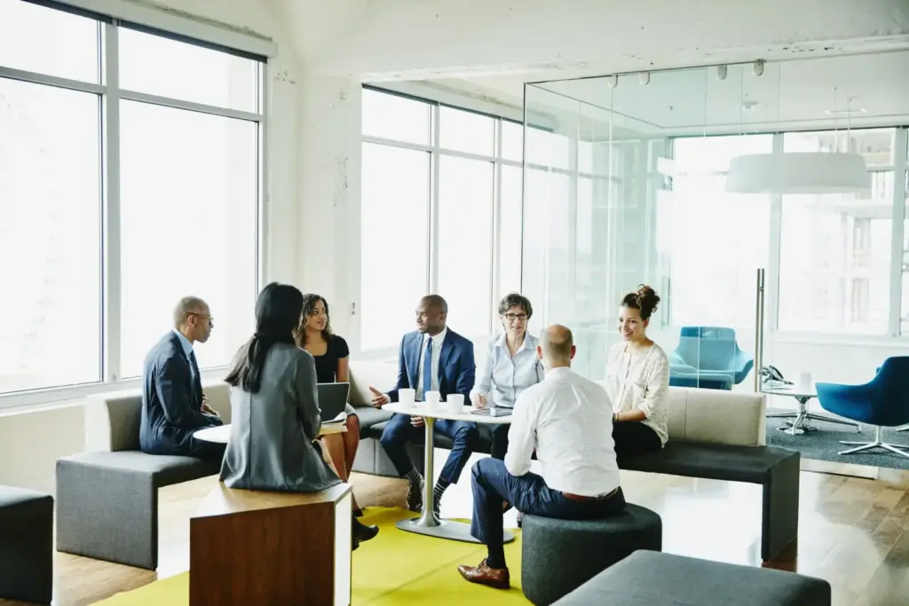 people sitting around a modern desk in the office