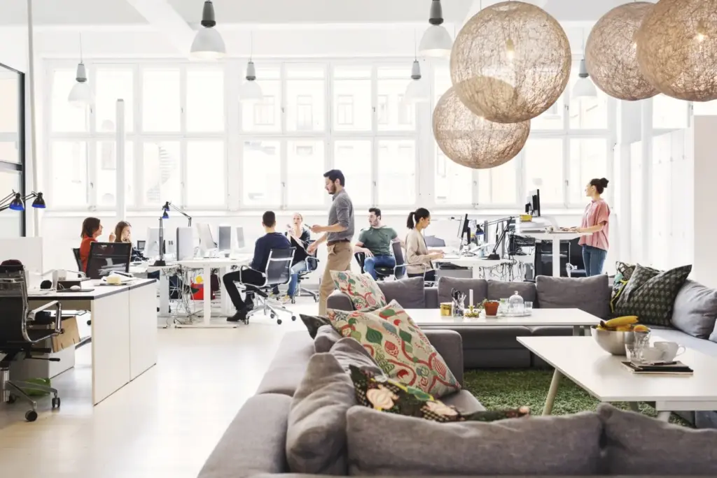 Open concept office with couches and people at their desks