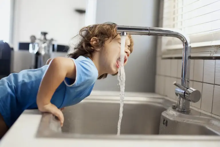 Small boy drinking water
