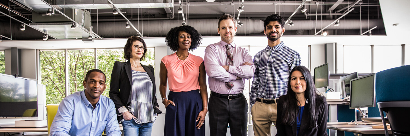 diverse group of people in an office facing the camera