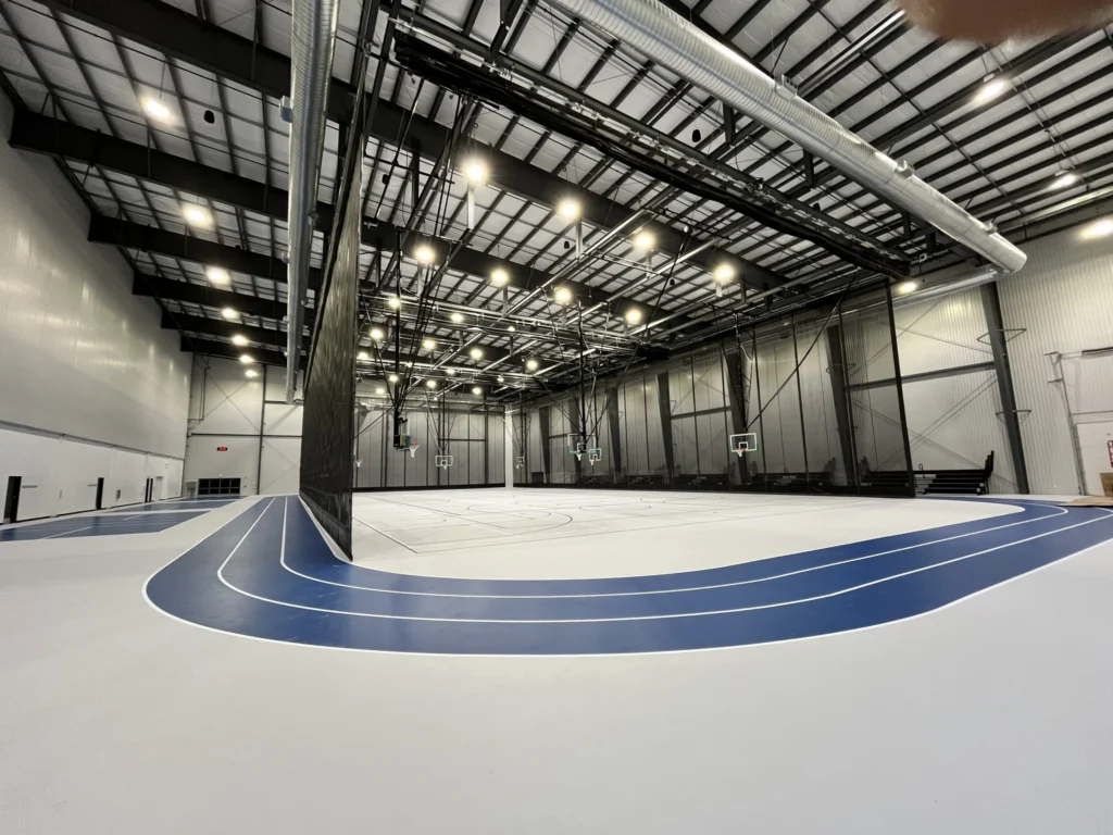 interior running track with basketball nets suspended from the ceiling